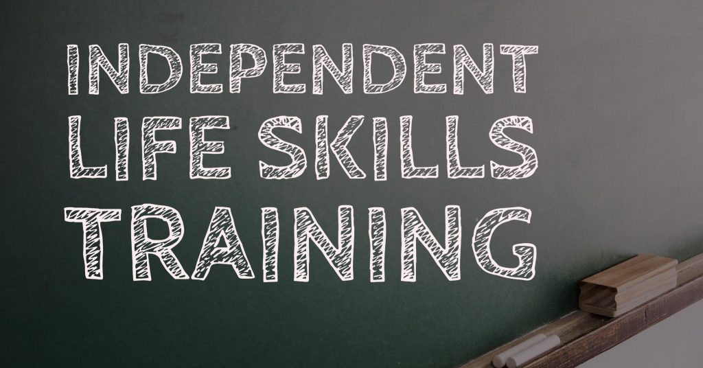 Independent Life Skills Training text on a blackboard background