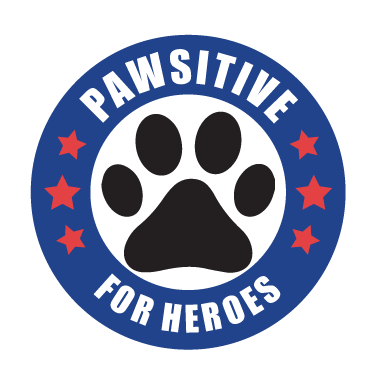 The image is a blue circle with a black paw print in the center. There is white text inside and around the blue circle that reads Pawsitive for Heroes. Each side has 3 red stars.